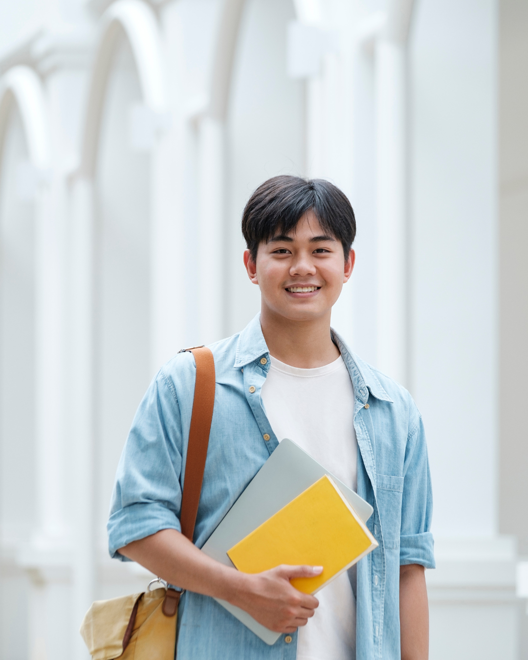Smiling student carrying books